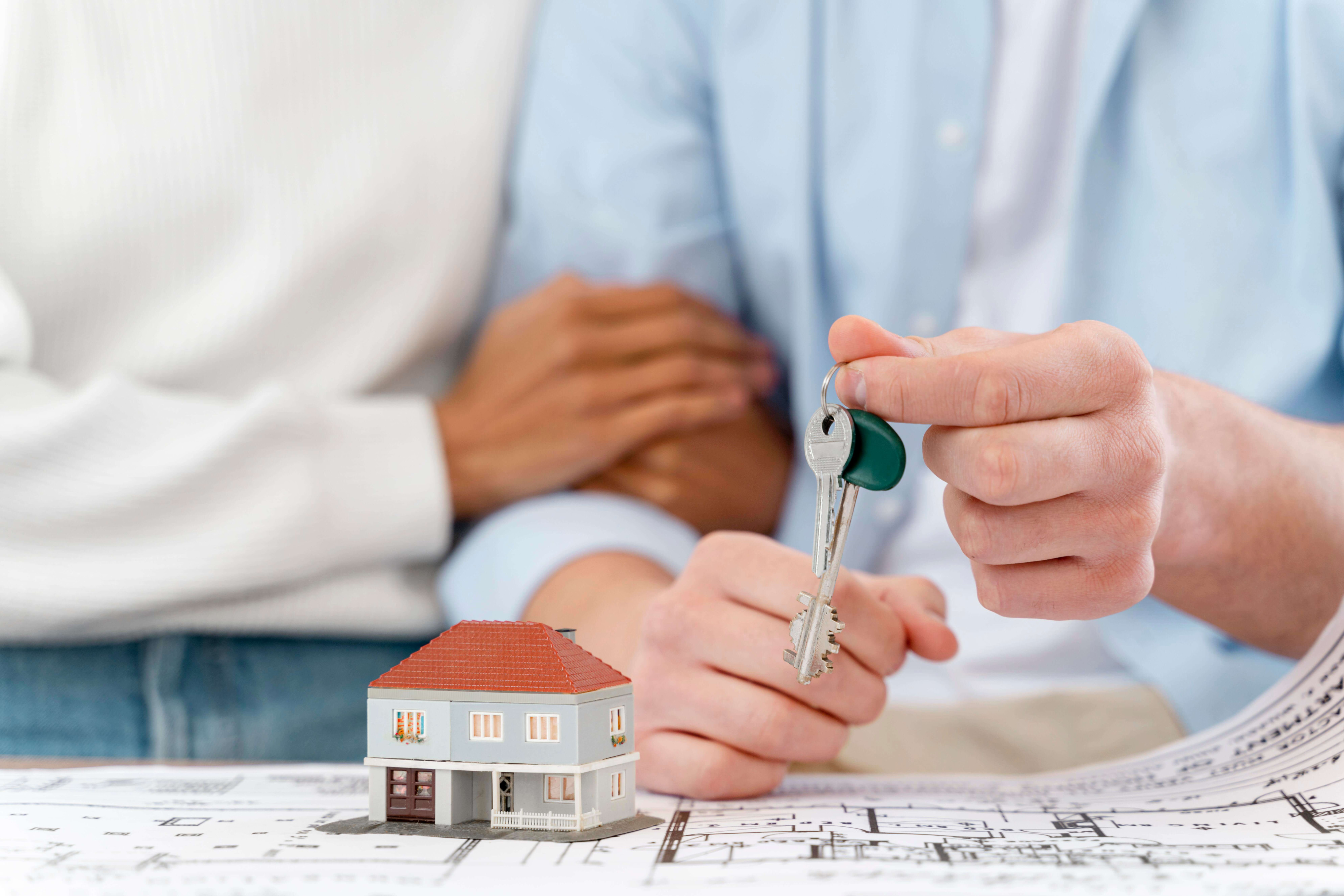 embraced-defocused-couple-holding-keys-their-new-house